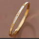 18K gold PVD plated stainless steel hinged bangle bracelet.